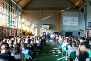 3. Na scenie konferansjerzy – chłopak i dziewczyna w tle za nimi po prawej stronie wyświetlony napis „Bo Wolność nie jest za darmo!
